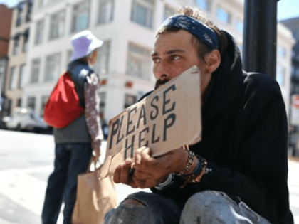 Andrew Loy begs along a sidewalk in downtown San Francisco on June, 28, 2016. Homelessness