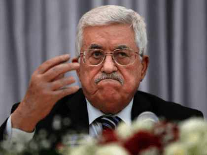 Palestinian President Mahmud Abbas gestures as he speaks during a Christmas lunch with mem