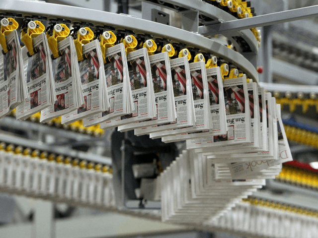 Freshly printed copies of the San Francisco Chronicle move on an overhead conveyor belt No