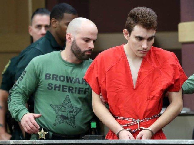 Nikolas Cruz is escorted into the courtroom for his arraignment at the Broward County Courthouse March 14, 2018 in in Fort Lauderdale, Florida. Cruz is accused of opening fire at Marjory Stoneman Douglas High School in Parkland on Feb. 14, killing 17 students and adults. (Photo by Amy Beth Bennett-Pool/Getty …