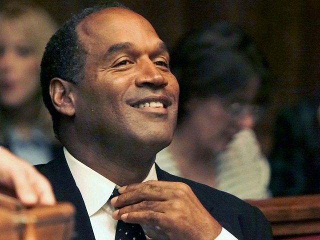 Miami, UNITED STATES: (FILES) Photo dated 09 October 2001 shows O.J. Simpson adjusting his tie before the jury selection of his trial at the Miami circuit court in Miami. Simpson describes in a Fox television interview 'how he would have carried out' the murder of his ex-wife and her friend, …
