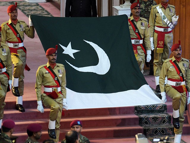 Pakistani soldiers carry national flag during a ceremony to mark the country's Independenc