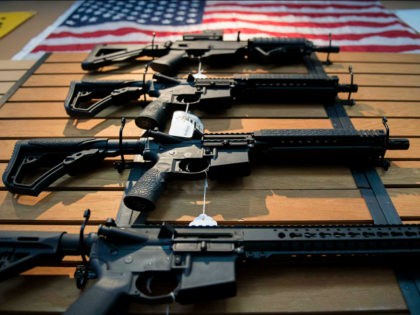 Assault rifles hang on the wall for sale at Blue Ridge Arsenal in Chantilly, Virginia, on October 6, 2017. / AFP PHOTO / JIM WATSON (Photo credit should read JIM WATSON/AFP/Getty Images)