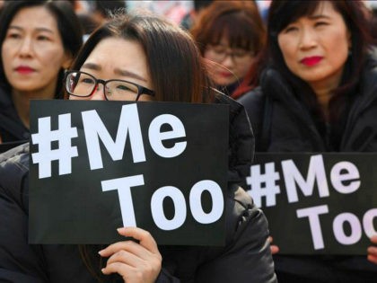 TOPSHOT - South Korean demonstrators hold banners during a rally to mark International Wom