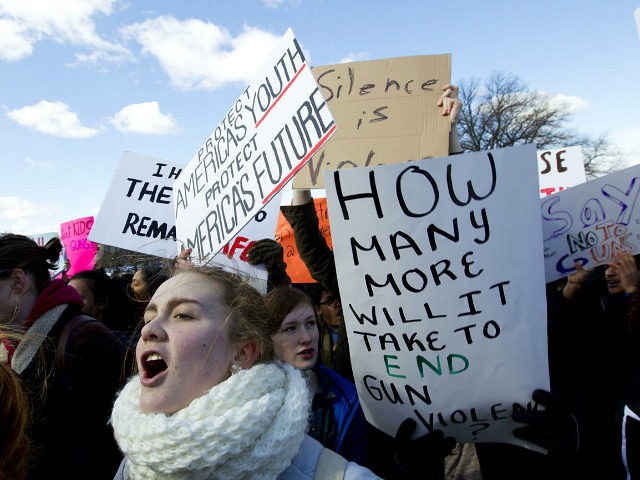 Students hold up their signs during a rally asking for gun control outside of the U.S. Capitol building, in Wednesday, March 14, 2018, in Washington. One month after a mass shooting in Florida, students and advocates across the country participate in walkouts and protests to call on Congress for action. …