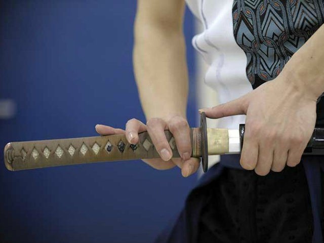 LIFESTYLE-JAPAN-HEALTH-FITNESS Takafuji Ukon (C), a 31-year-old choreographer, dancer and fitness expert shows his skills of sword dancing after his 'Katana Exercise' fitness lesson at a studio in Tokyo on May 1, 2010. Japan's ancient samurai swords were once used to slice apart enemies, but in a new fitness craze they …