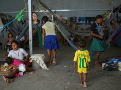 Venezuelan refugees rest inside a temporary shelter in the city of Pacaraima in Brazil