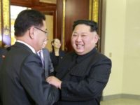 North Korean leader Kim Jong Un (R) shakes hands with South Korean chief delegate Chung Eui-yong during their meeting in Pyongyang