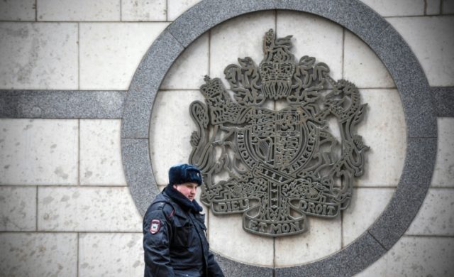 A police officer patrols outside the British embassy in Moscow Russia vows to respond to Britain over spy attack 'any minute'