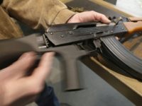 A bump stock is installed on an AK-47 and its movement is demonstrated at Good Guys Gun and Range in Orem, Utah