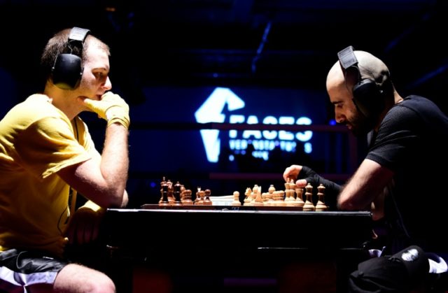 Daniel Biman (L) and Mohamad Kadija attend a chessboxing fight during an amateur fight event at the Intellectual Fight Club IX in Berlin. Checkmate or knockout: Chess boxing lands a punch