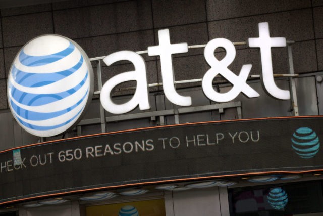AT T Antitrust Trial In this Oct. 24, 2016, file photo, the AT&T logo is positioned above one of its retail stores in New York. Opening arguments in the federal government’s case to block AT&T’s efforts to gobble up Time Warner have been postponed until Thursday, March 22, 2018. (AP Photo/Mark Lennihan, File) The Associated Press