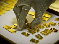 In this Tuesday Oct. 9, 2012 photo, a gold press operator collects 10 gram gold blanks to press them with the logo of the Emirates Gold company in Dubai, United Arab Emirates. Gold prices remained relatively steady in 2012, close to $1,700 an ounce. (AP Photo/Kamran Jebreili)