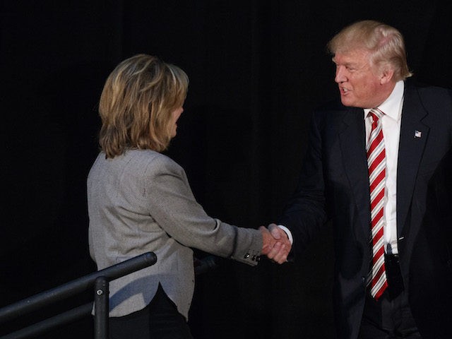 Republican presidential candidate Donald Trump, center, shakes hands with Rep. Marsha Blac