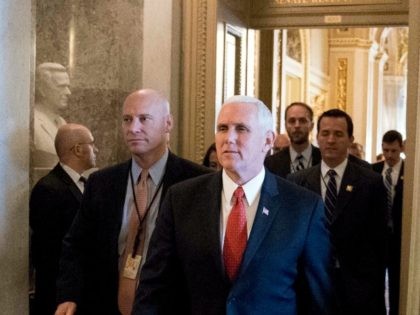 Vice President Mike Pence, center, and White House Director of Legislative Affairs Marc Short, center left, walks through the halls of Capitol Hill, Tuesday, Dec. 19, 2017,