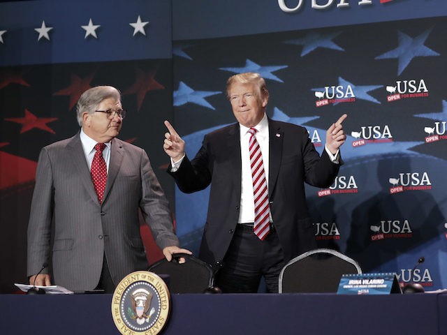 President Donald Trump, center, gestures as he is introduced before speaking at an event to promote his $1.5 trillion tax cut package at Bucky Dent Park in Hialeah, Fla., Monday, April 16, 2018. Looking on are Maximo Alvarez, left, CEO, Sunshine Distributor and Irina Vilarino, right, owner, Las Vegas Cuban …