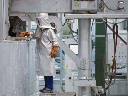 A worker in protective gear checks the production process during the opening of the 200 million euro aluminum recycling and casting center of US company Novelis Inc., headquartered in Atlanta, US, in Nachterstedt, central Germany, Wednesday, Oct. 1, 2014. Located adjacent to the company’s existing aluminum rolling mill, the new …