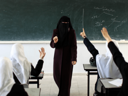 A Palestinian teacher speaks in class at a school in Gaza City on April 2, 2013. A law ban