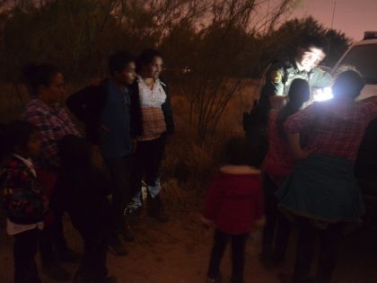 A RGV Sector Border Patrol agent process an illegal immigrant family group at Rincon Bend.