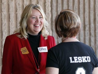 In this Jan. 27, 2018, file photo, Arizona State Rep. and U.S. Representative candidate Debbie Lesko speaks with a constituent during the meeting of the state committee of the Arizona Republican Party in Phoenix. The sprawling suburbs west of Phoenix may put a brake on Democratic optimism following surprising special …