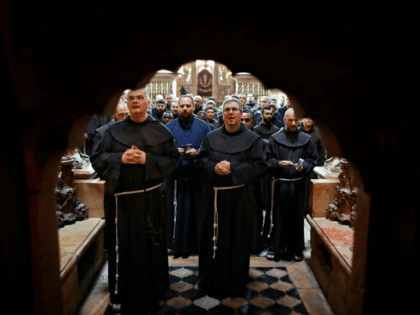 Father Francesco Patton (2-R), a superior in the Franciscan order known as 'Custo', and friars prays in front of the entrance of the Tomb of Jesus, where Jesus Christ is believed to be buried, inside the Church of the Holy Sepulchre at the end of the weekly Via Dolorosa (Way …