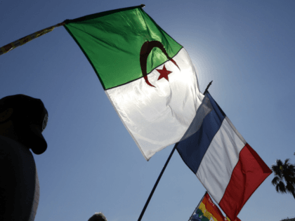 People wave the French and Algerian flags during a demonstration against a municipal order banning the 'conspicuous showing' of foreign flags issued by French right-wing UMP mayor of Nice Christian Estrosi (not pictured), following Algeria's fans celebrations during the 2014 FIFA World Cup, on July 05, 2014, in Nice, southeastern …
