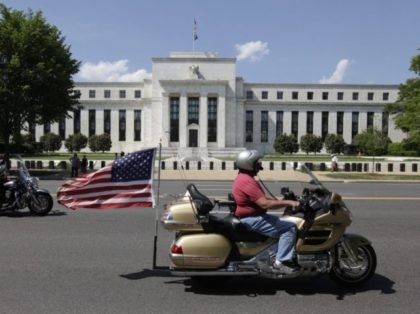 Motorcycclist participating in the The Rolling Thunder First Amendment Demonstration Run ride by the Federal Reserve Building in Washington, DC, on May 24, 2015. The Rolling Thunder First Amendment Demonstration Run is an annual event to pay tribute to current and former US military members. AFP PHOTO / CHRIS KLEPONIS …
