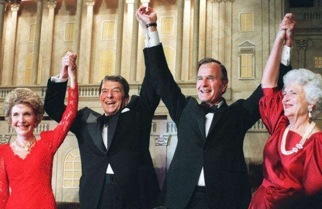 WASHINGTON, DC - NOVEMBER 5: US President Ronald Reagan (l) raises his arms in the air w