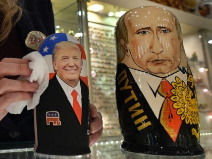 An employee polishes traditional Russian wooden nesting dolls, Matryoshka dolls, depicting US President-elect Donald Trump (L) and Russian President Vladimir Putin at a gift shop in central Moscow on January 16, 2017, four days ahead of Trump's inauguration. / AFP PHOTO / Alexander NEMENOV (Photo credit should read ALEXANDER NEMENOV/AFP/Getty …