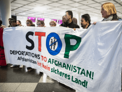 People take part in a demonstration against the deportation of some 50 Afghan refugees fro