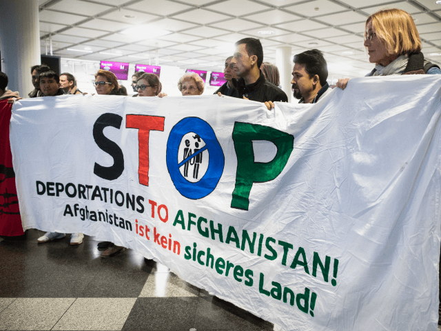 People take part in a demonstration against the deportation of some 50 Afghan refugees fro