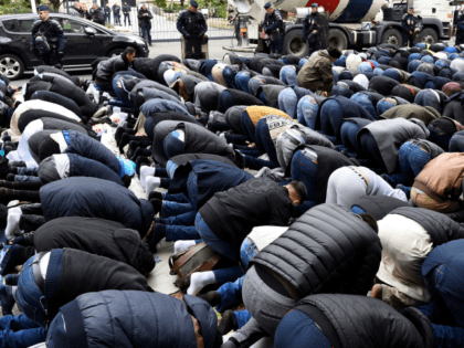 Muslims pray in the street during a protest in front of the city hall of Clichy, near Pari