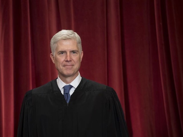 US Supreme Court Associate Justice Neil Gorsuch stands for an official photo with other me