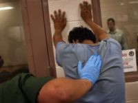 GettyImages-82210567 A Laredo Sector Border Patrol agent processes an illegal alien after apprehension. (File Photo: John Moore/Getty Images)