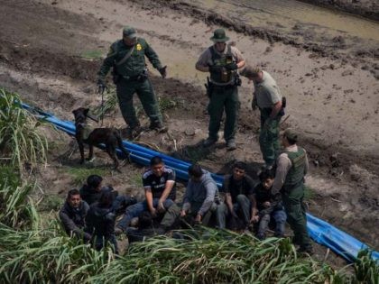 Border Patrol agents apprehend illegal immigrants near the US border with Mexico on, March 27, 2018 in the Rio Grande Valley Sector, near McAllen, Texas.