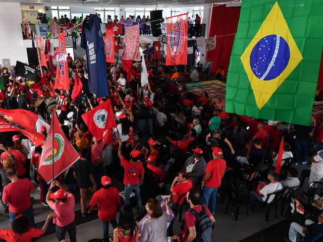 Supporters of former Brazilian president Luiz Inacio Lula da Silva demonstrate as they gather at the metalworkers' union building in Sao Bernardo do Campo, in metropolitan Sao Paulo, Brazil, on April 6, 2018 as the ex-president decides whether to resist an order to surrender and start a 12-year prison sentence …