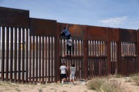 MEXICO-US-BORDER-MIGRATION A young Mexican helps a compatriot to climb the metal wall that divides the border between Mexico and the United States to cross illegally to Sunland Park, from Ciudad Juarez, Chihuahua state, Mexico on April 6, 2018. US President Donald Trump on April 5, 2018 said he would send thousands …
