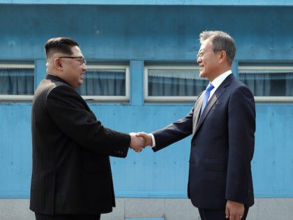 PANMUNJOM, SOUTH KOREA - APRIL 27: North Korean Leader Kim Jong Un (L) and South Korean President Moon Jae-in (R) shake hands over the military demarcation line upon meeting for the Inter-Korean Summit on April 27, 2018 in Panmunjom, South Korea. Kim and Moon meet at the border today for …