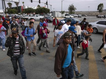 Central American migrants travelling in the "Migrant Via Crucis" arrive at the Padre Chava's kitchen soup for breakfast and legal counseling, in Tijuana, Baja California State, Mexico, on April 27, 2018. - The US has threatened to arrest around 100 Central American migrants if they try to sneak in from …