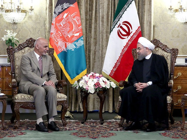 In this photo released by official website of the office of the Iranian Presidency, Afghanistan President Ashraf Ghani, left, meets with Iranian President Hassan Rouhani at the Saadabad Palace in Tehran, Iran, Monday, May 23, 2016. (Iranian Presidency Office via AP)