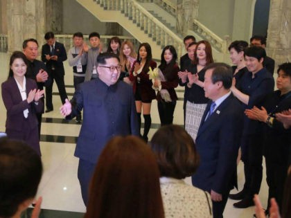 This picture released from North Korea's official Korean Central News Agency (KCNA) on April 2, 2018 and taken on April 1, 2018 shows North Korean leader Kim Jong Un (centre L) speaking to South Korean musicians as his wife Ri Sol-Ju (far L) and South Korea's Culture, Sports and Tourism …