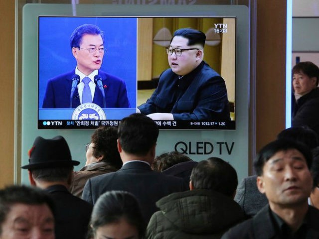 In this March 7, 2018, file photo, people watch a TV screen showing images of North Korean