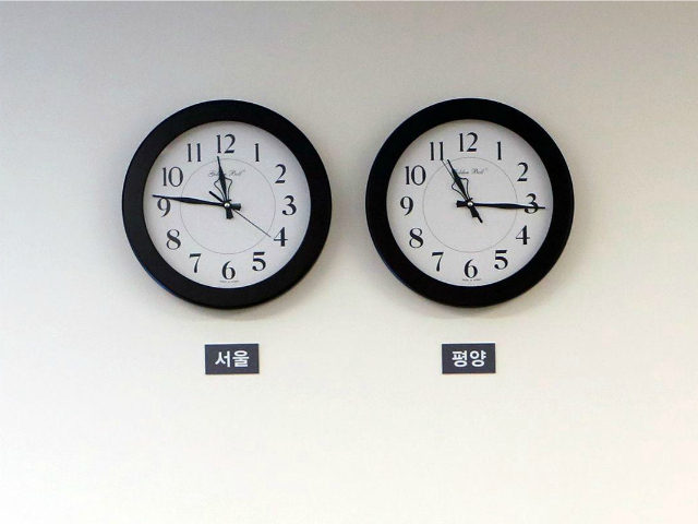 Clocks show the respective time in Seoul and Pyongyang in a meeting room at the Peace Hous