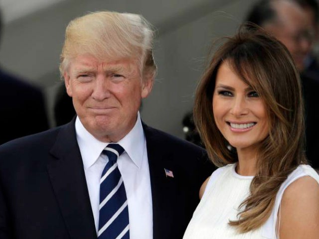 In this July 7, 2017 photo, President Donald Trump, left, and first lady Melania Trump smile prior to a concert on the first day of the G-20 summit in Hamburg, northern Germany. The White House has announced that President Trump and the first lady have decided not to participate in …