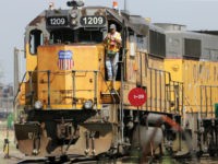 Union-Pacific-train-worker-front-ap In this Thursday, July 20, 2017, photo, a Union Pacific employee is seen on board a locomotive in a rail yard in Council Bluffs, Iowa. Union Pacific Corp. reports financial results Thursday, Oct. 26, 2017. (AP Photo/Nati Harnik)