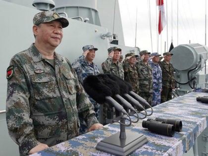 Chinese President Xi Jinping reviews a naval parade Thursday in the South China Sea.
