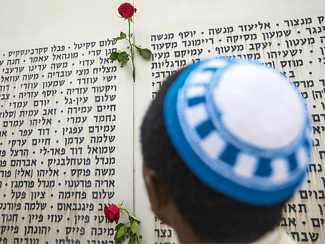 An Israeli man prays in front of a commemorative plaque celebrating fallen soldiers and decorated with roses at the Armored Corps memorial, following a ceremony to mark Remembrance Day (or Memorial Day) on May 5, 2014 at Latrun Junction, near Jerusalem. Israel is marking Remembrance Day to commemorate the fallen …