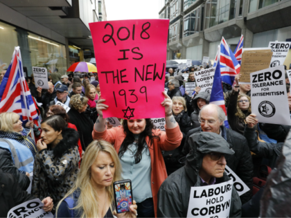 People hold up placards and Union flags as they gather for a demonstration organised by the Campaign Against Anti-Semitism outside the head office of the British opposition Labour Party in central London on April 8, 2018. Labour leader Jeremy Corbyn has been under increasing pressure to address multiple allegations of …