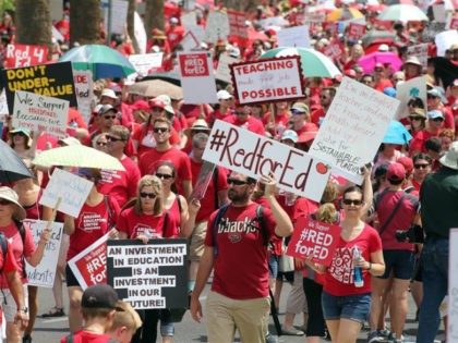 Arizona teachers march toward the State Capitol as part of a rally for the #REDforED movement on April 26, 2018 in Phoenix, Arizona. Teachers state-wide staged a walkout strike on Thursday in support of better wages and state funding for public schools. (Photo by Ralph Freso/Getty Images)