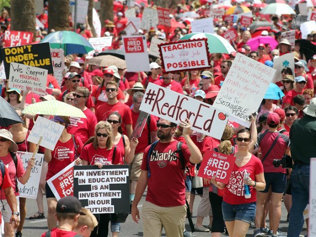 Arizona teachers march toward the State Capitol as part of a rally for the #REDforED movem